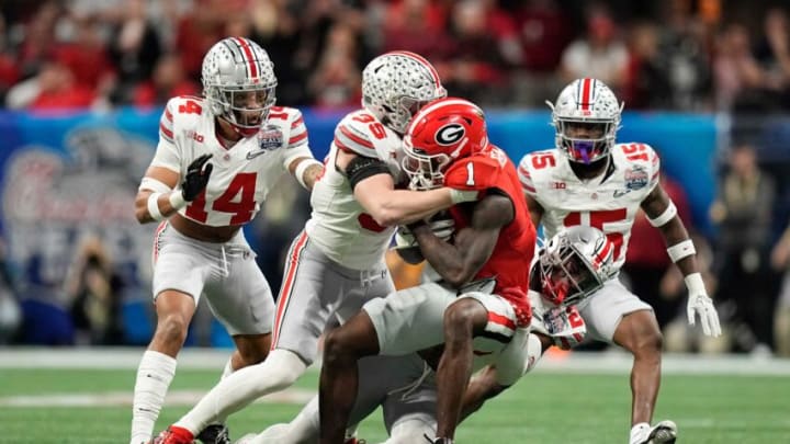 Dec 31, 2022; Atlanta, Georgia, USA; Ohio State Buckeyes cornerback Cameron Brown (26) and linebacker Tommy Eichenberg (35) stop Georgia Bulldogs wide receiver Marcus Rosemy-Jacksaint (1) during the first half of the Peach Bowl in the College Football Playoff semifinal at Mercedes-Benz Stadium. Mandatory Credit: Adam Cairns-The Columbus DispatchNcaa Football Peach Bowl Ohio State At Georgia