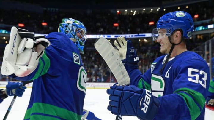 VANCOUVER, BC - OCTOBER 12: Bo Horvat #53 of the Vancouver Canucks congratulates teammate Jacob Markstrom #25 after winning their NHL game against the Philadelphia Flyers at Rogers Arena October 12, 2019 in Vancouver, British Columbia, Canada. Vancouver won 3-2 in a shootout. (Photo by Jeff Vinnick/NHLI via Getty Images)