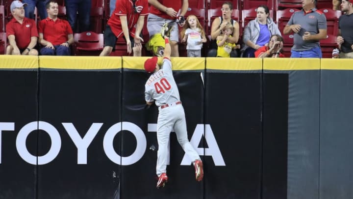 CINCINNATI, OHIO - SEPTEMBER 04: Adam Haseley #40 of the Philadelphia Phillies reaches up above the outfield wall to catch the ball hit by the Freddy Galvis #3 of the Cincinnati Reds at Great American Ball Park on September 04, 2019 in Cincinnati, Ohio. (Photo by Andy Lyons/Getty Images)