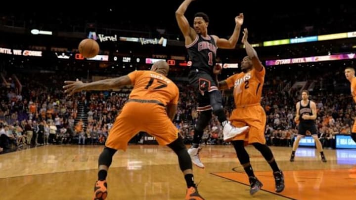 Jan 30, 2015; Phoenix, AZ, USA; Chicago Bulls guard Derrick Rose (1) looses control of the basketball against the Phoenix Suns forward P.J. Tucker and guard Eric Bledsoe in the first half at US Airways Center. Mandatory Credit: Jennifer Stewart-USA TODAY Sports