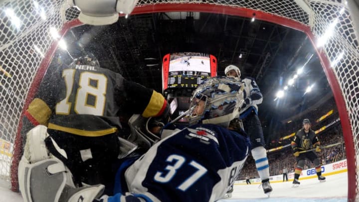 LAS VEGAS, NV - MAY 18: James Neal #18 of the Vegas Golden Knights falls into the net against goalie Connor Hellebuyck #37 of the Winnipeg Jets in Game Four of the Western Conference Final during the 2018 NHL Stanley Cup Playoffs at T-Mobile Arena on May 18, 2018 in Las Vegas, Nevada. (Photo by Jeff Bottari/NHLI via Getty Images)