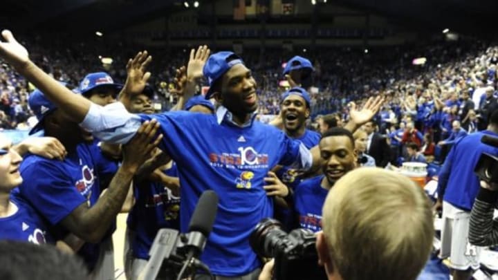 Mar 5, 2014; Lawrence, KS, USA; Kansas Jayhawks center Joel Embiid (center) celebrates after the game against the Texas Tech Red Raiders at Allen Fieldhouse. Kansas won the game 82-57. Mandatory Credit: John Rieger-USA TODAY Sports1