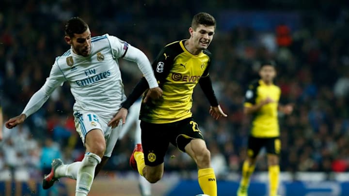 MADRID, SPAIN - DECEMBER 06: Christian Pulisic of Borussia Dortmund (R) competes for the ball with Theo Hernandez (L) during the UEFA Champions League group H match between Real Madrid and Borussia Dortmund at Estadio Santiago Bernabeu on December 6, 2017 in Madrid, Spain. (Photo by Gonzalo Arroyo Moreno/Getty Images)