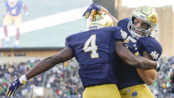 SOUTH BEND, IN - NOVEMBER 06: Kevin Austin Jr. #4 and Michael Mayer #87 of the Notre Dame Fighting Irish celebrate a touchdown during the first half against the Navy Midshipme at Notre Dame Stadium on November 6, 2021 in South Bend, Indiana. (Photo by Michael Hickey/Getty Images)