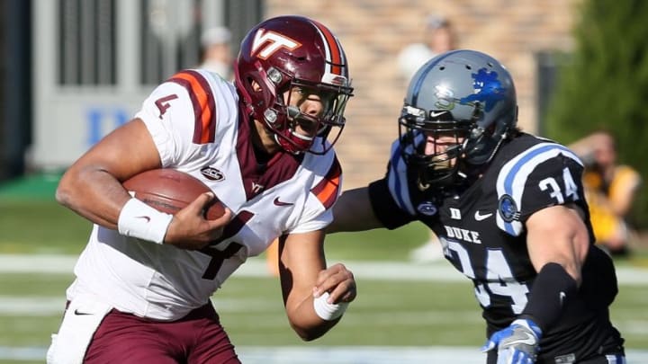 Nov 5, 2016; Durham, NC, USA; Virginia Tech Hokies quarterback Jerod Evans (4) runs the ball against Duke Blue Devils linebacker Ben Humphreys (34) in the first half at Wallace Wade Stadium. Mandatory Credit: Mark Dolejs-USA TODAY Sports