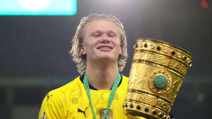 BERLIN, GERMANY - MAY 13: Erling Haaland of Borussia Dortmund celebrates with the trophy after winning the DFB Cup final match between RB Leipzig and Borussia Dortmund at Olympic Stadium on May 13, 2021 in Berlin, Germany. Sporting stadiums around Germany remain under strict restrictions due to the Coronavirus Pandemic as Government social distancing laws prohibit fans inside venues resulting in games being played behind closed doors. (Photo by Martin Rose/Getty Images)