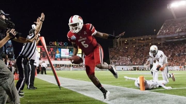 Louisville Cardinals quarterback Teddy Bridgewater (5) reacts after scoring a touchdown during the second half of the Russell Athletic Bowl against the Miami Hurricanes at Florida Citrus Bowl Stadium. Mandatory Credit: Rob Foldy-USA TODAY Sports