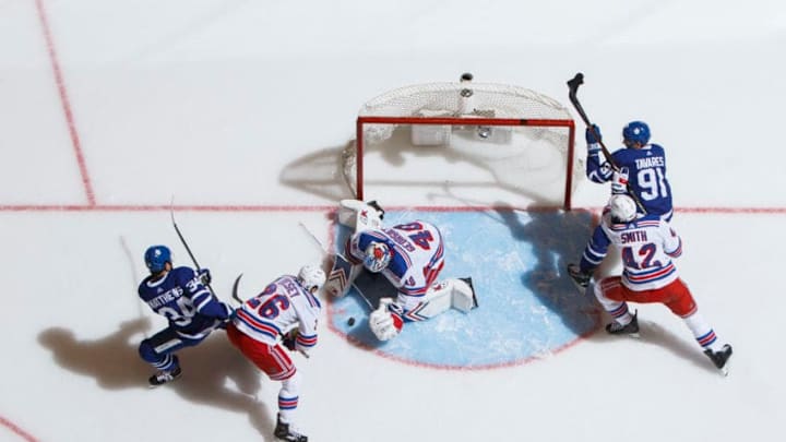 TORONTO, ON - MARCH 23: Alexandar Georgiev #40 of the New York Rangers makes a save as Jimmy Vesey #26 battles against Auston Matthews #34 of the Toronto Maple Leafs during the third period at the Scotiabank Arena on March 23, 2019 in Toronto, Ontario, Canada. (Photo by Mark Blinch/NHLI via Getty Images)