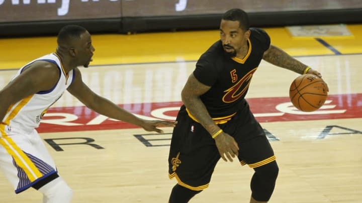 June 19, 2016; Oakland, CA, USA; Cleveland Cavaliers guard J.R. Smith (5) moves the ball against Golden State Warriors forward Draymond Green (23) in the second half in game seven of the NBA Finals at Oracle Arena. Mandatory Credit: Cary Edmondson-USA TODAY Sports