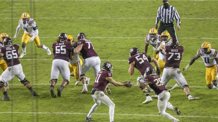 Nov 28, 2020; College Station, Texas, USA; Texas A&M Aggies quarterback Kellen Mond (11) hands the ball off to running back Isaiah Spiller (28) against the LSU Tigers in the second half at Kyle Field. Mandatory Credit: Thomas Shea-USA TODAY Sports