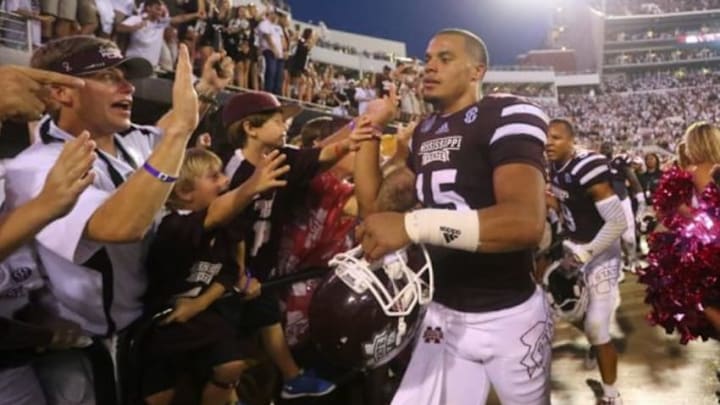 Oct 11, 2014; Starkville, MS, USA; Mississippi State Bulldogs quarterback Dak Prescott (15) walks through the celebration line after the game against the Auburn Tigers at Davis Wade Stadium. Mississippi State Bulldogs defeated the Auburn Tigers 38-23. Mandatory Credit: Spruce Derden-USA TODAY Sports