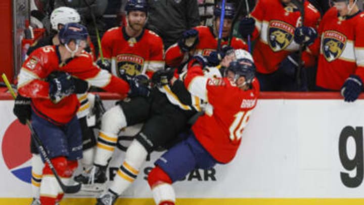 Apr 21, 2023; Sunrise, Florida, USA; Florida Panthers center Aleksander Barkov (16) and Boston Bruins defenseman Charlie McAvoy (73) fight during the third period in game three of the first round of the 2023 Stanley Cup Playoffs at FLA Live Arena. Mandatory Credit: Sam Navarro-USA TODAY Sports