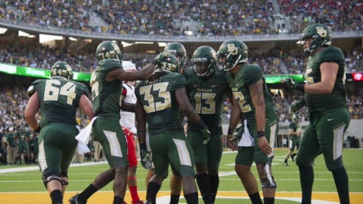 WACO, TX - SEPTEMBER 2: Jamychal Hasty #33 of the Baylor Bears celebrates with teammates after a 13 yard touchdown run against the Liberty Flames during the first half at McLane Stadium on September 2, 2017 in Waco, Texas. (Photo by Cooper Neill/Getty Images)