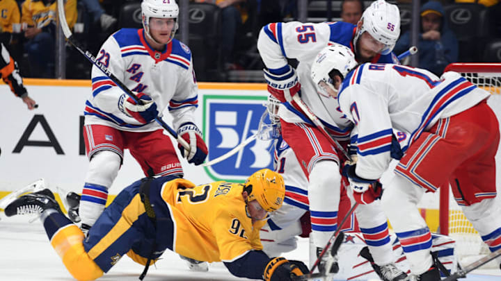Oct 21, 2021; Nashville, Tennessee, USA; Nashville Predators center Ryan Johansen (92) is knocked to the ice as he attempts a shot in front of the New York Rangers net during the first period at Bridgestone Arena. Mandatory Credit: Christopher Hanewinckel-USA TODAY Sports