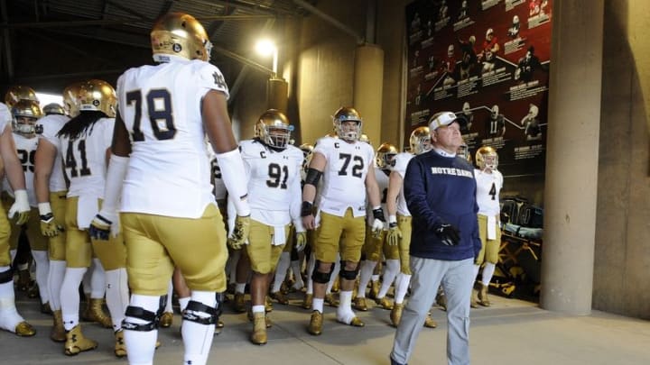 November 28, 2015; Stanford, CA, USA; Notre Dame Fighting Irish head coach Brian Kelly (right) leads the players out onto the field to play against Stanford Cardinal during at Stanford Stadium. Mandatory Credit: Gary A. Vasquez-USA TODAY Sports