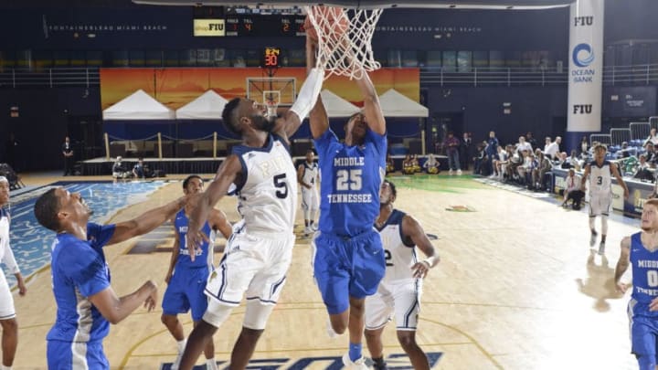 MIAMI, FL - JANUARY 04: FIU guard Eric Lockett (5) and Middle Tennessee forward Karl Gamble (25) reach for a rebound during a college basketball game between the Middle Tennessee State University Blue Raiders and the Florida International University Panthers on January 4, 2018 Florida. Middle Tennessee defeated FIU 71-66 in overtime. (Photo by Richard C. Lewis/Icon Sportswire via Getty Images)