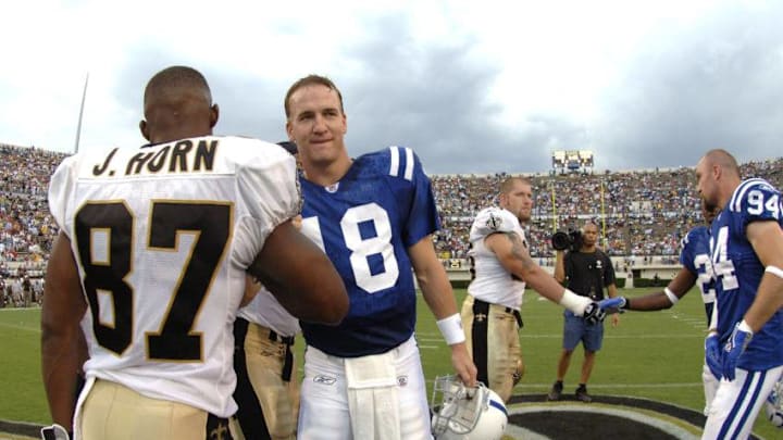 Indianapolis Colts quarterback Peyton Manning greets New Orleans Saints wide receiver Joe Horn before the coin toss at Veterans Memorial Stadium in Jackson, Mississippi on August 26, 2006. The Colts won 27-14. (Photo by A. Messerschmidt/Getty Images)