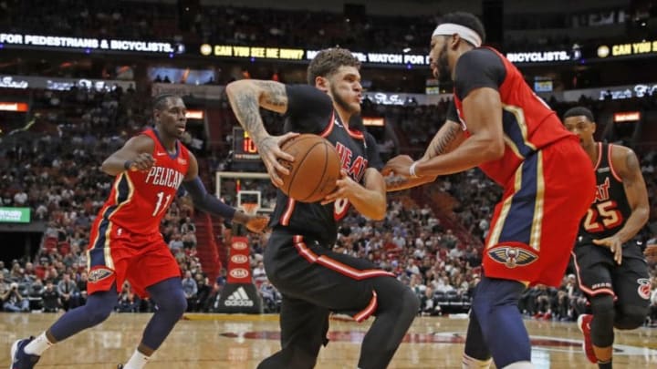 The Miami Heat's Tyler Johnson, middle, drives to the basket as the New Orleans Pelicans' Anthony Davis, right, defends in the first quarter on Saturday, Dec. 23, 2017, at AmericanAirlines Arena in Miami. (Al Diaz/Miami Herald/TNS via Getty Images)