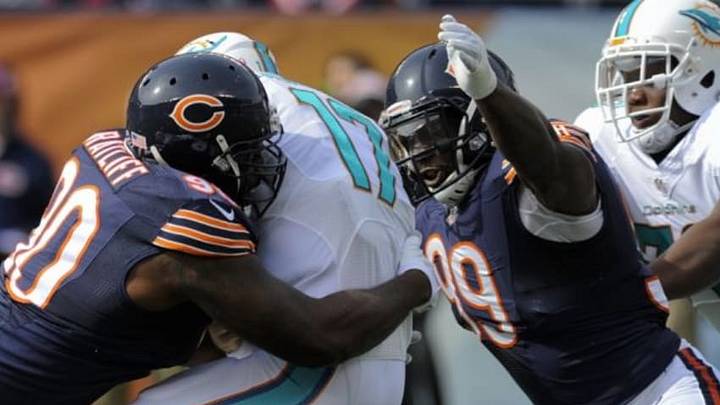 Oct 19, 2014; Chicago, IL, USA; Chicago Bears defensive tackle Jeremiah Ratliff (90) and Chicago Bears defensive end Lamarr Houston (99) sack Miami Dolphins quarterback Ryan Tannehill (17) in the first quarter of their game at Soldier Field. Mandatory Credit: Matt Marton-USA TODAY Sports