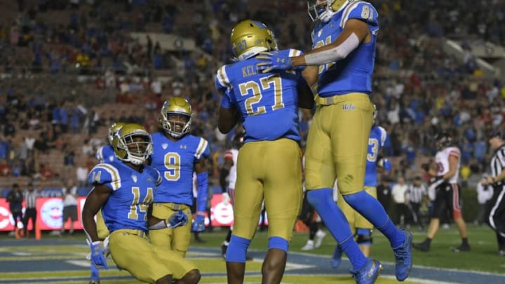 PASADENA, CA - OCTOBER 26: Joshua Kelley #27 of the UCLA Bruins is congratulated by team mates after scoring a touchdown against Utah Utes in the first half at Rose Bowl on October 26, 2018 in Pasadena, California. (Photo by John McCoy/Getty Images) PASADENA, CA - OCTOBER 26: Joshua Kelley #27 of the UCLA Bruins is congratulated by team mates after scoring a touchdown against Utah Utes in the first half at Rose Bowl on October 26, 2018 in Pasadena, California. (Photo by John McCoy/Getty Images)