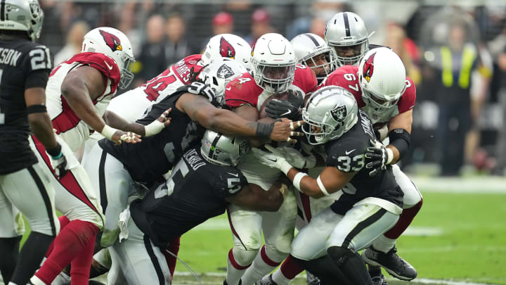 Sep 18, 2022; Paradise, Nevada, USA; Arizona Cardinals running back Darrel Williams (24) is stopped by Las Vegas Raiders linebacker Divine Deablo (5), Las Vegas Raiders safety Roderic Teamer (33) and Las Vegas Raiders defensive tackle Kendal Vickers (95) during a game at Allegiant Stadium. Mandatory Credit: Stephen R. Sylvanie-USA TODAY Sports