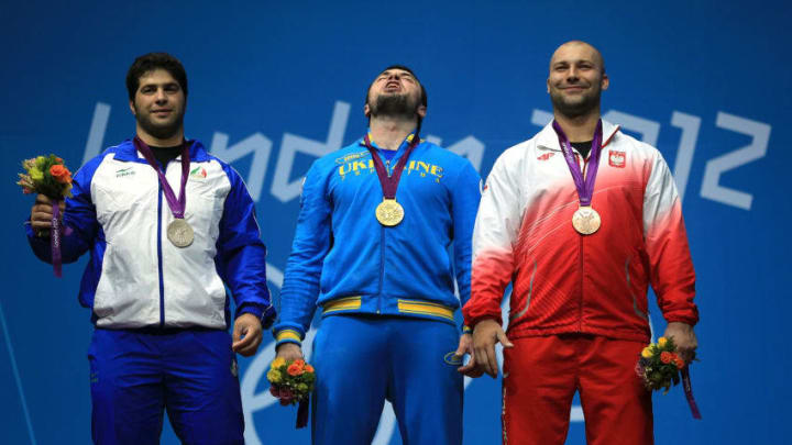 LONDON, ENGLAND - AUGUST 06: (L-R) Silver medalist Navab Nasirshelal of Islamic Republic of Iran, gold medalist Oleksiy Torokhtiy of Ukraine and bronze medalist Bartlomiej Wojciech Bonk of Poland pose on the podium during the medal ceremony for the Men's 105kg Weightlifting on Day 10 of the London 2012 Olympic Games at ExCeL on August 6, 2012 in London, England. (Photo by Phil Walter/Getty Images)