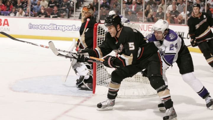 ANAHEIM, CA - FEBRUARY 18: Alexander Frolov #24 of the Los Angeles Kings reaches around for the puck against Steve Montador #5 of the Anaheim Ducks during the game on February 18, 2009 at Honda Center in Anaheim, California. (Photo by Debora Robinson/NHLI via Getty Images)