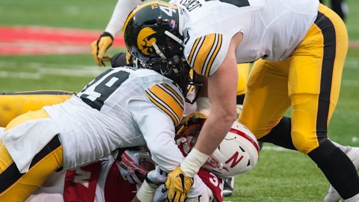 Nov 27, 2015; Lincoln, NE, USA; Nebraska Cornhuskers running back Terrell Newby (34) is tackled by Iowa Hawkeyes linebacker Josey Jewell (43) and defensive back Miles Taylor (19) during the first half at Memorial Stadium. Mandatory Credit: Jeffrey Becker-USA TODAY Sports