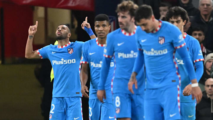 Atlético Madrid left back Renan Lodi (left) celebrates after scoring against Manchester United in the UEFA Champions League. (Photo by PAUL ELLIS/AFP via Getty Images)