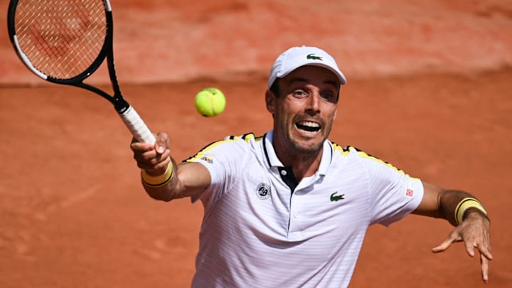Spain's Roberto Bautista Agut returns the ball to Switzerland's Henri Laaksonen during their men's singles second round tennis match on Day 4 of The Roland Garros 2021 French Open tennis tournament in Paris on June 2, 2021. (Photo by Anne-Christine POUJOULAT / AFP) (Photo by ANNE-CHRISTINE POUJOULAT/AFP via Getty Images)