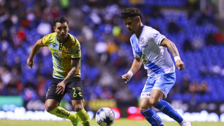 Puebla's Maxi Araujo (right) tormented the Atlas defense for much of their match, a game that ended in a 1-1 draw. (Photo by Agustin Cuevas/Getty Images)