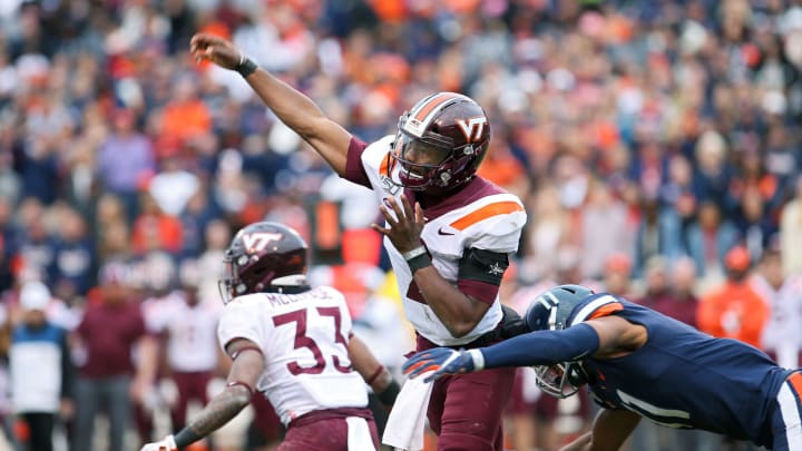 CHARLOTTESVILLE, VA – NOVEMBER 29: Hendon Hooker #2 of the Virginia Tech Hokies throws a pass as he is hit by Charles Snowden #11 of the Virginia Cavaliers in the second half during a game at Scott Stadium on November 29, 2019 in Charlottesville, Virginia. (Photo by Ryan M. Kelly/Getty Images)