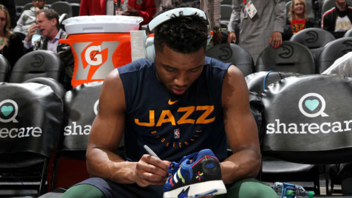 ATLANTA, GA - MARCH 21: Donovan Mitchell #45 of the Utah Jazz signs autograph on sneaker for a fan before the game against the Atlanta Hawks on March 21, 2019 at State Farm Arena in Atlanta, Georgia. Copyright 2019 NBAE (Photo by Jasear Thompson/NBAE via Getty Images)