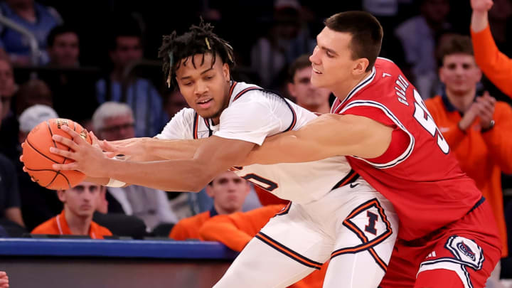 Dec 5, 2023; New York, New York, USA; Illinois Fighting Illini guard Terrence Shannon Jr. (0) is fouled by Florida Atlantic Owls center Vladislav Goldin (50) during the second half at Madison Square Garden. Mandatory Credit: Brad Penner-USA TODAY Sports