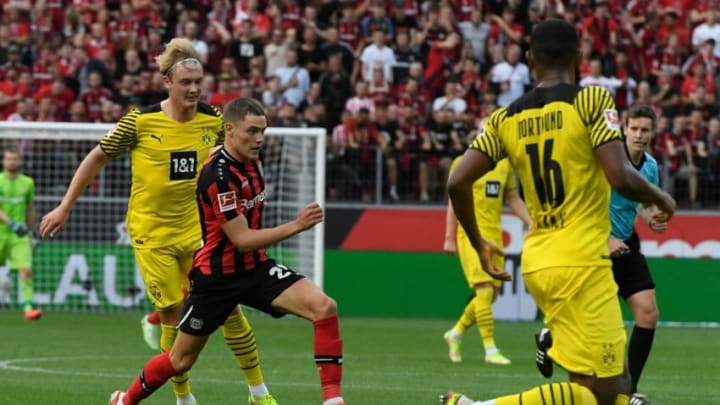 Dortmund's German forward Julian Brandt (L) and Leverkusen's German forward Florian Wirtz (2nd L) vie for the ball during the German first division Bundesliga football match between Bayer 04 Leverkusen and Borussia Dortmund in Leverkusen, western Germany, on September 11, 2021. - DFL REGULATIONS PROHIBIT ANY USE OF PHOTOGRAPHS AS IMAGE SEQUENCES AND/OR QUASI-VIDEO (Photo by Roberto Pfeil / AFP) / DFL REGULATIONS PROHIBIT ANY USE OF PHOTOGRAPHS AS IMAGE SEQUENCES AND/OR QUASI-VIDEO (Photo by ROBERTO PFEIL/AFP via Getty Images)