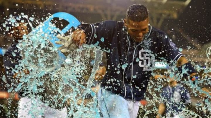 Aug 30, 2014; San Diego, CA, USA; San Diego Padres shortstop Alexi Amarista (right) is doused by catcher Rene Rivera (left) after driving in the winning run in the tenth inning against the Los Angeles Dodgers to beat the Dodgers 2-1 at Petco Park. Mandatory Credit: Jake Roth-USA TODAY Sports