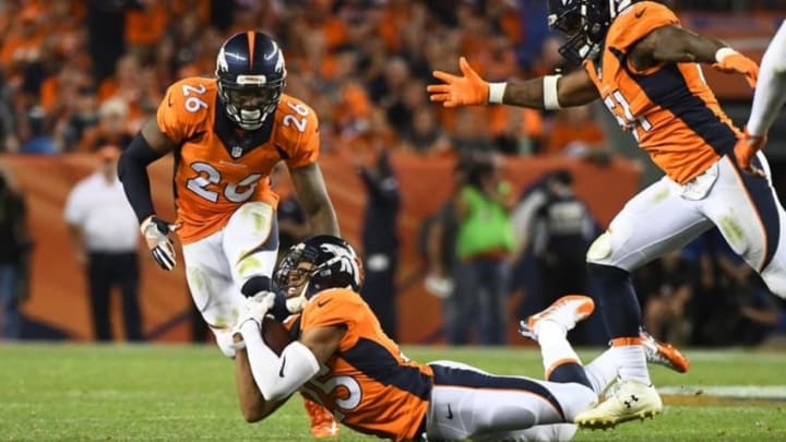 Sep 8, 2016; Denver, CO, USA; Denver Broncos cornerback Chris Harris (25) pulls in a interception in the fourth quarter against the Carolina Panthers at Sports Authority Field at Mile High. Mandatory Credit: Ron Chenoy-USA TODAY Sports