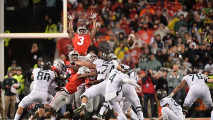 COLUMBUS, OH - NOVEMBER 21: Michael Thomas #3 of the Ohio State Buckeyes goes high to attempt to block a 41-yard field goal attempt by Michael Geiger #4 of the Michigan State Spartans as time expires at Ohio Stadium on November 21, 2015 in Columbus, Ohio. The kick was good and Michigan State defeated Ohio State 17-14. (Photo by Jamie Sabau/Getty Images)