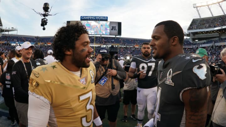 Jan 26, 2020; Orlando, Florida, USA; NFC quarterback Russell Wilson of the Seattle Seahawks (3) and AFC quarterback Deshaun Watson of the Houston Texans (4) talk after the 2020 NFL Pro Bowl at Camping World Stadium. The AFC defeated the NFC 38-33. Mandatory Credit: Kirby Lee-USA TODAY Sports