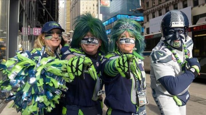 Feb 1, 2014; New York, NY, USA; Seattle Seahawks fans pose on Super Bowl Boulevard on Broadway in advance of Super Bowl XLVIII. From left: Laura Carter and Jeff Schumaier and Dede Schumaier and Brad Carter. Mandatory Credit: Kirby Lee-USA TODAY Sports
