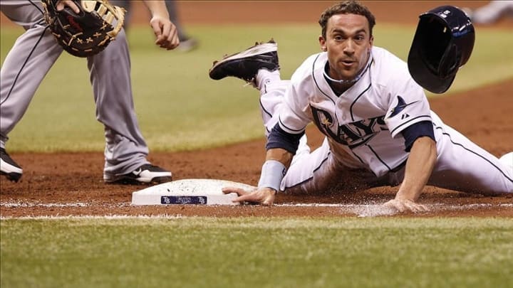 Aug 15, 2013; St. Petersburg, FL, USA; Tampa Bay Rays left fielder Sam Fuld (5) slides safely back into first base during the third inning against the Seattle Mariners at Tropicana Field. Mandatory Credit: Kim Klement-USA TODAY Sports