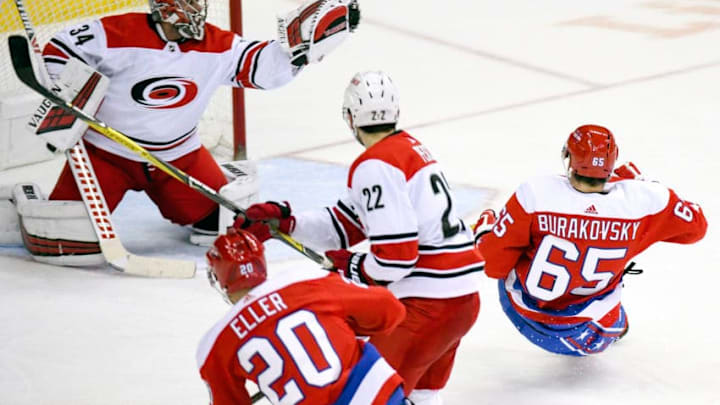 WASHINGTON, DC - DECEMBER 27: Carolina Hurricanes goaltender Petr Mrazek (34) makes a third period save on a shot by Washington Capitals left wing Andre Burakovsky (65) on December 27, 2018, at the Capital One Arena in Washington, D.C. (Photo by Mark Goldman/Icon Sportswire via Getty Images)