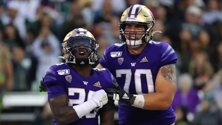 SEATTLE, WASHINGTON - SEPTEMBER 14: Richard Newton #28 celebrates with Jared Hilbers #70 of the Washington Huskies after scoring a one yard touchdown against the Hawaii Rainbow Warriors in the fourth quarter during their game at Husky Stadium on September 14, 2019 in Seattle, Washington. (Photo by Abbie Parr/Getty Images)