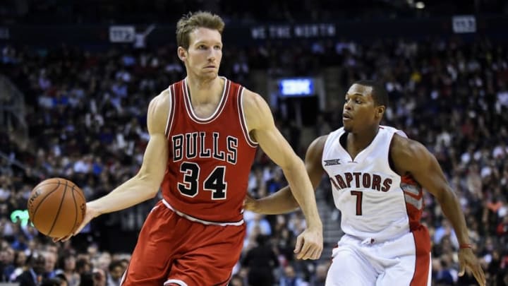 Nov 13, 2014; Toronto, Ontario, CAN; Chicago Bulls forward Mike Dunleavy (34) dribbles the ball past Toronto Raptors guard Kyle Lowry (7) during the first quarter at Air Canada Centre. Mandatory Credit: Peter Llewellyn-USA TODAY Sports
