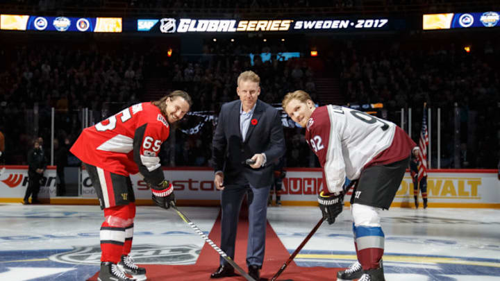STOCKHOLM, SWE - NOVEMBER 11: Erik Karlsson #65 of the Ottawa Senators and Gabriel Landeskog #92 of the Colorado Avalanche take a ceremonial face-off with Daniel Alfredsson before the Global Series game at Ericsson Globe on November 11, 2017 in Stockholm, Sweden. (Photo by Andre Ringuette/NHLI via Getty Images)