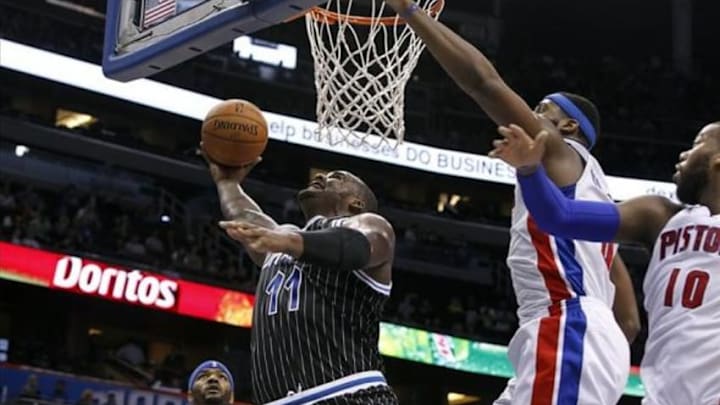 Feb 5, 2014; Orlando, FL, USA; Orlando Magic power forward Glen Davis (11) shoots over Detroit Pistons center Andre Drummond (0) and power forward Greg Monroe (10) during the second half at Amway Center. Orlando Magic defeated the Detroit Pistons 112-98. Mandatory Credit: Kim Klement-USA TODAY Sports