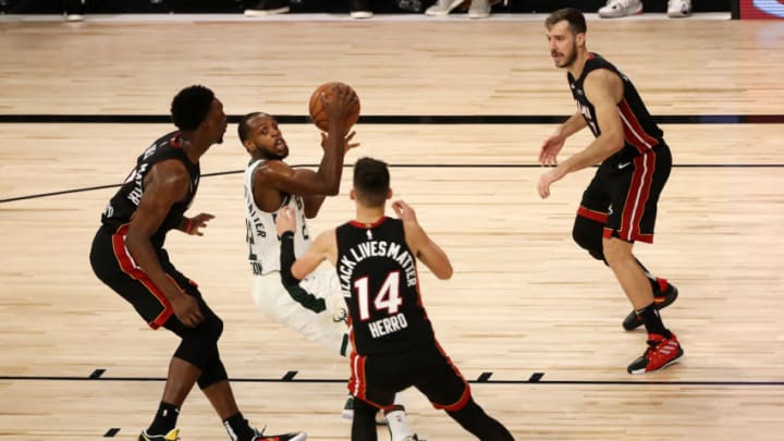 Khris Middleton #22 of the Milwaukee Bucks scrambles with the ball during the fourth quarter against the Miami Heat in Game Three. (Photo by Mike Ehrmann/Getty Images)