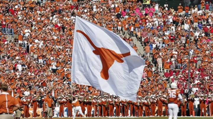 Oct 10, 2015; Dallas, TX, USA; Texas Longhorns cheerleader carries a Texas flag against the Oklahoma Sooners during Red River rivalry at Cotton Bowl Stadium. Mandatory Credit: Matthew Emmons-USA TODAY Sports