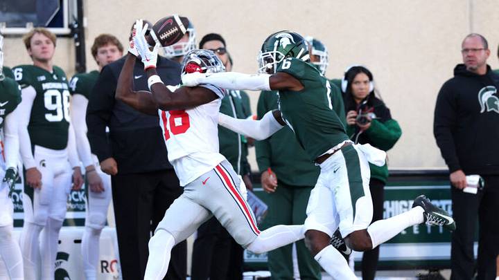 EAST LANSING, MICHIGAN - OCTOBER 08: Marvin Harrison Jr. #18 of the Ohio State Buckeyes catches a first half pass in front of Ameer Speed #6 of the Michigan State Spartans at Spartan Stadium on October 08, 2022 in East Lansing, Michigan. (Photo by Gregory Shamus/Getty Images) EAST LANSING, MICHIGAN - OCTOBER 08: Marvin Harrison Jr. #18 of the Ohio State Buckeyes catches a first half pass in front of Ameer Speed #6 of the Michigan State Spartans at Spartan Stadium on October 08, 2022 in East Lansing, Michigan. (Photo by Gregory Shamus/Getty Images)