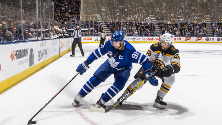 TORONTO, ON – NOVEMBER 15: John Tavares #91 of the Toronto Maple Leafs skates against Matt Grzelcyk #48 of the Boston Bruins during the third period at the Scotiabank Arena on November 15, 2019 in Toronto, Ontario, Canada. (Photo by Mark Blinch/NHLI via Getty Images)